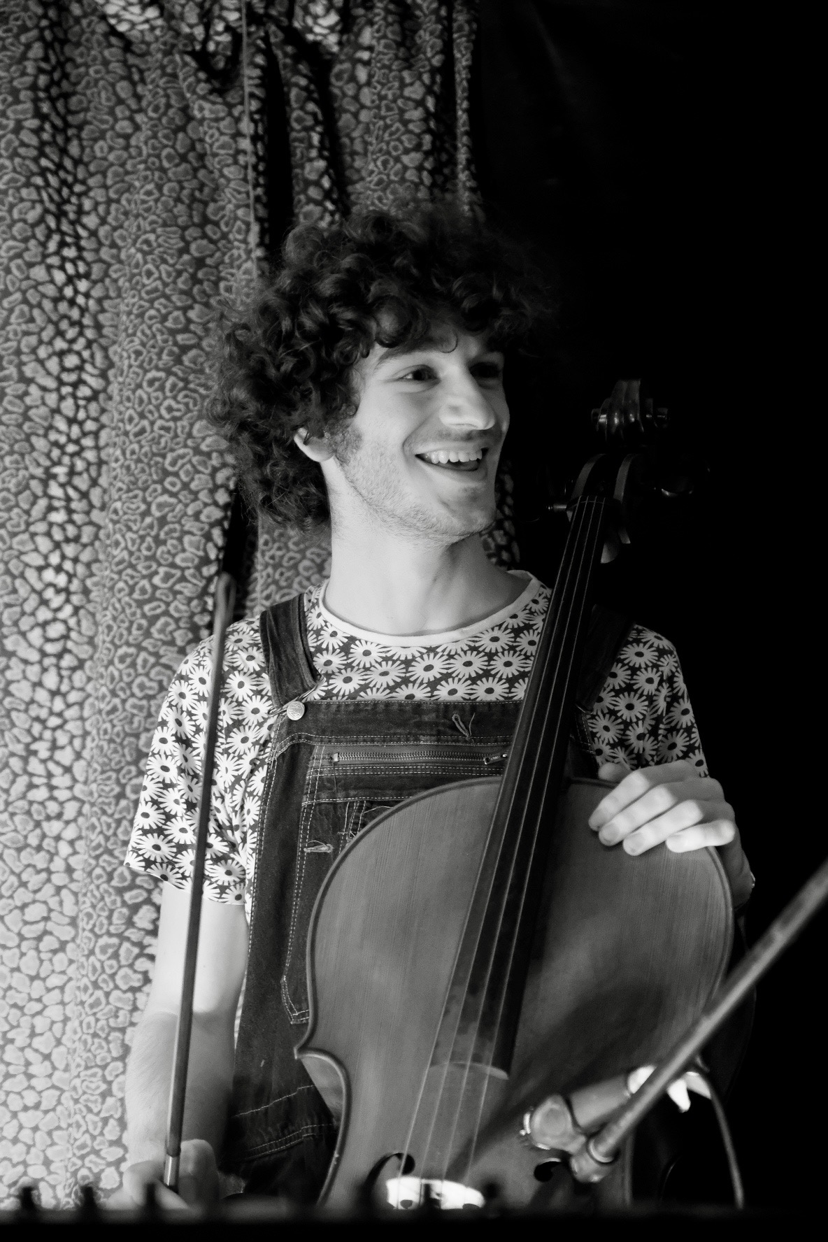 Linus smiling, holding a cello